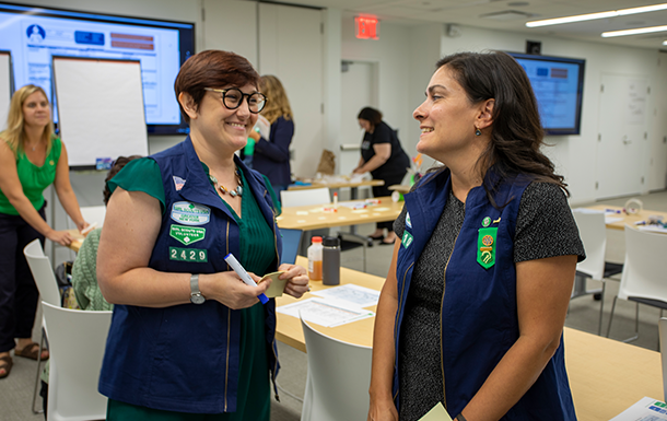 two volunteers in uniform at a meeting