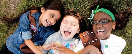 Three Girl Scout Brownies smiling outdoors Three Girl Scout Brownies smiling outdoors