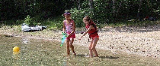 Two Girl Scouts by the lake at a GSEMA Camp