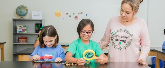 A Girl Scout volunteer with two Girl Scouts A Girl Scout volunteer with two Girl Scouts