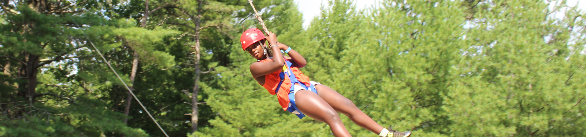  girl on ropes course at camp 