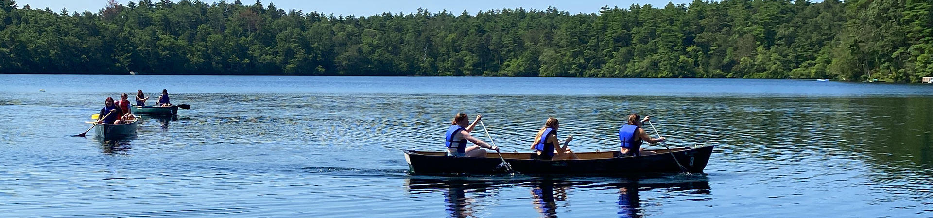  group of girls in canoes on the lake at camp 