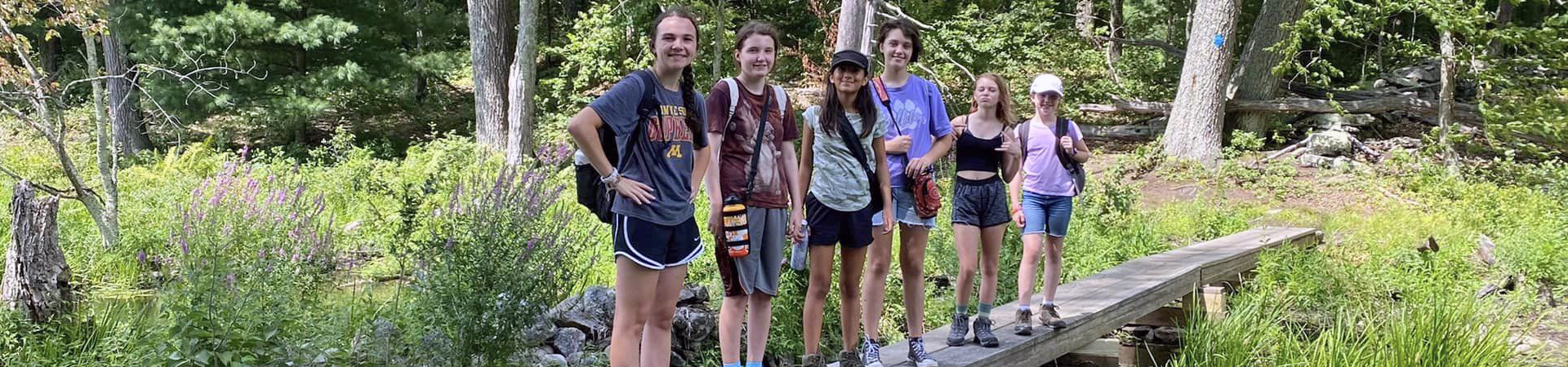  group of girls hiking in the woods 