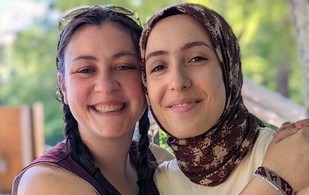 two women side by side hugging