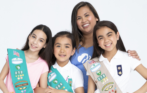 three girl scouts with a volunteer