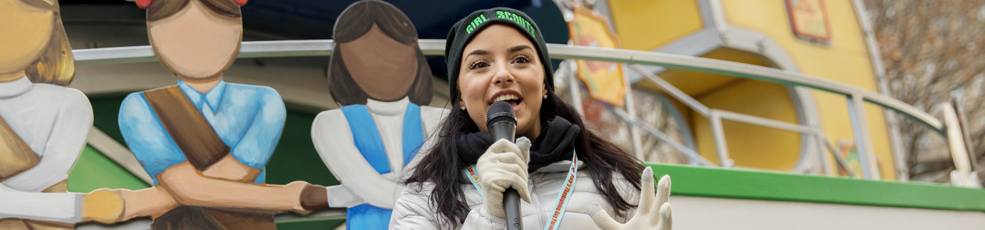  three young girl scouts with their arms wrapped around one another and smiling at the camera 